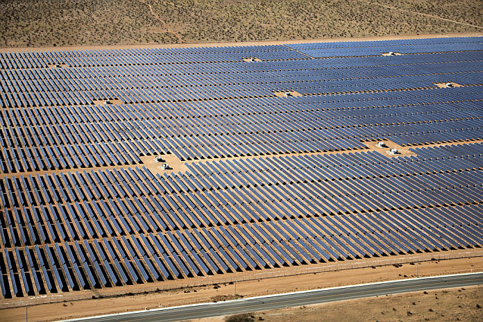 An array of solar panels is seen in the desert near Victorville
