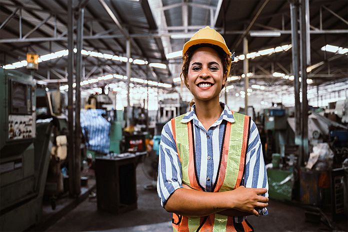 attractive young african woman smiling and working engineering i