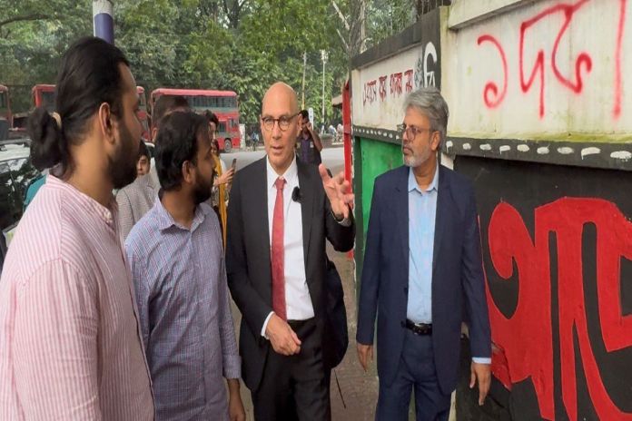 High Commissioner for Human Rights Volker with students showing him the grafitti done during the July protest near the Dhaka University, Bangladesh.